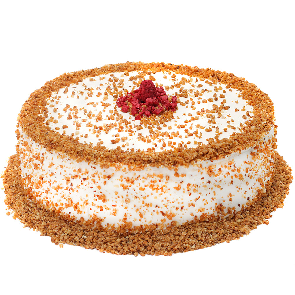 Torta de merengue con almendras acarameladas, rellena de manjar y frambuesas